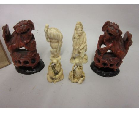 Two 19th Century Japanese carved ivory netsuke in the form of seated figure together with a pair of similar 19th Century figu