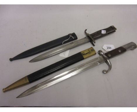 German Solingen wooden and steel gripped bayonet with leather and brass scabbard, together with another 20th Century bayonet 