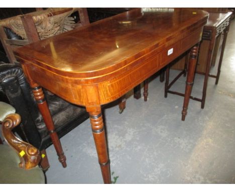 Late George III mahogany crossbanded and line inlaid D shaped fold-over card table on turned tapering supports