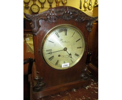 Late 19th or early 20th Century mahogany bracket clock with carved applied decoration the circular silvered dial with Roman n
