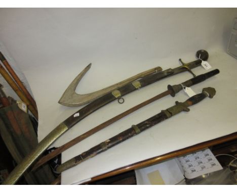 19th Century Eastern steel sabre with horn and brass grip together with another Eastern sword and another similar dagger with