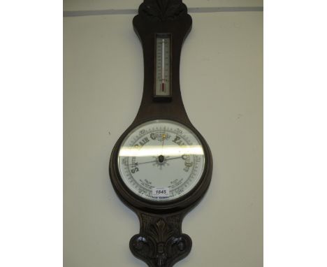 Early 20th Century carved oak aneroid barometer with painted glass dial