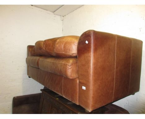 Similar smaller mid tan leather upholstered two seat sofa with a matching footstool