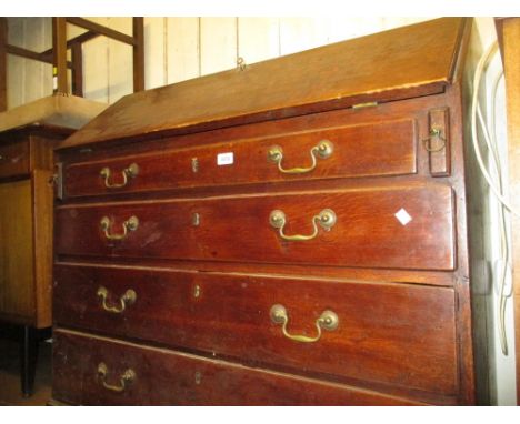 George III oak bureau with a fall front above four graduated drawers, with brass swan neck handles on bracket supports