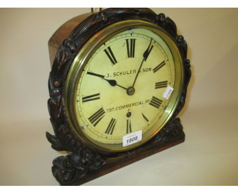19th Century oak cased wall clock with floral carved bezel, the painted enamel dial with Roman numerals inscribed J. Chuler &