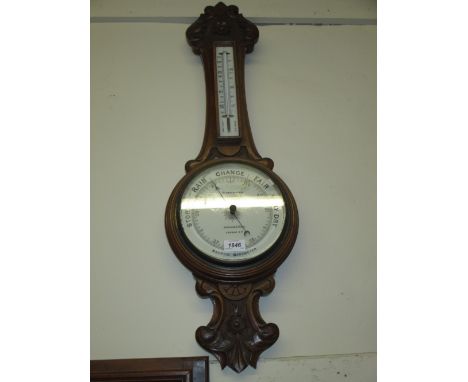 Early 20th Century carved walnut aneroid barometer / thermometer, signed Reynolds and Son, London