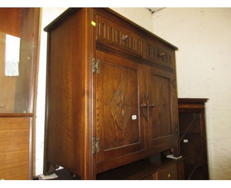 Small reproduction oak dresser with a boarded shelf back above drawers and two cupboard doors