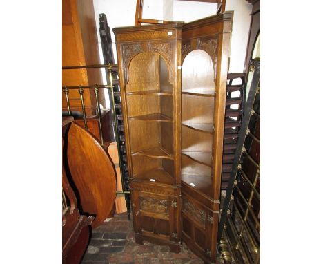 Pair of small good quality reproduction oak standing corner cabinets with open shelves above carved and panelled doors on bra