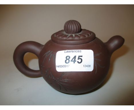 Small Chinese Yixing type terracotta teapot signed with a seal mark to base