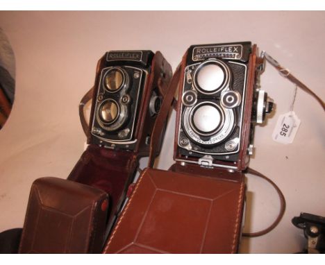 Rolleiflex twin lens camera with planer lens and built in light meter, and another similar camera with Zeiss lens together wi