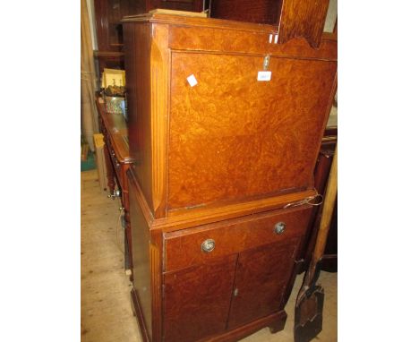 Mid 20th Century figured walnut drinks cabinet with a fall front above a single drawer, pair of doors and bracket feet