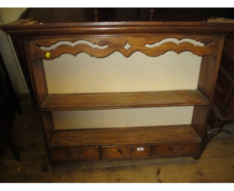 Oak wall mounted two shelf plate rack with three short drawers having brass swan neck handles