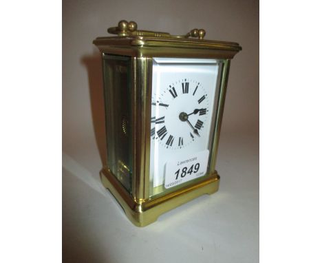 Small brass cased carriage clock, the enamel dial with Roman numerals and single train movement