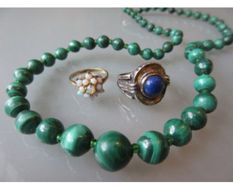 Yellow gold opal set flower head style ring, another cabochon blue stone set ring and a graduated malachite bead necklace