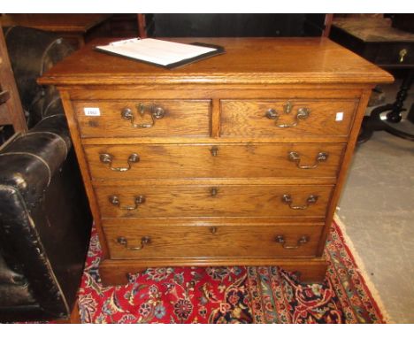 Good quality reproduction oak chest of two short and three long drawers with brass swan neck handles and bracket feet
