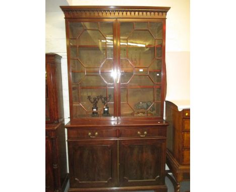 George III mahogany bookcase with a moulded cornice above a pair of astragal glazed doors, the base with two drawers above pa