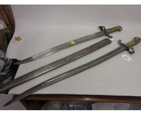 19th Century French bayonet with steel scabbard together with a similar bayonet (minus scabbard)