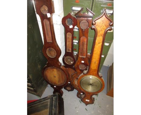 Victorian birds eye maple banjo shaped wheel barometer, three similar mahogany barometer cases and an Art Deco barometer case