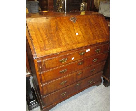 18th Century walnut and crossbanded bureau with a fall front enclosing a fitted interior above four graduated drawers with br