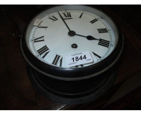 Black Japanned ship's bulk head clock with enamel dial, Roman numerals and single train movement (a/f), 8.75ins diameter