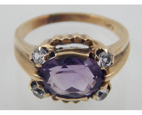 A yellow metal, amethyst, and white topaz set ring, the shank indistinctly stamped 10K. 