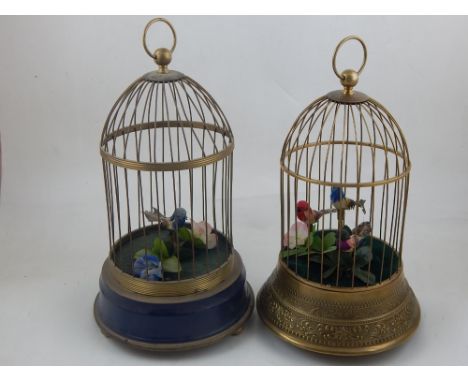 A 20th century novelty singing bird automaton in brass cage, boxed, together with another. (2)
