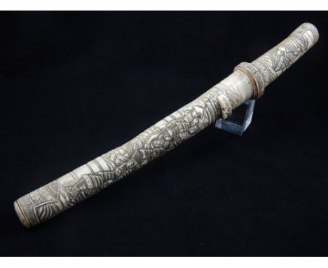 A late 19th century Japanese bone tanto, the scabbard and handle decorated with warriors in an interior, blade length 24cm.