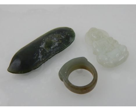 Two Chinese jade pendants, together with a jade ring. (3)