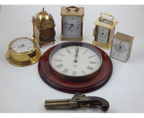 A modern laquered brass carriage timepiece retailed by Garrard and Co, together with three others, a bulkhead timepiece, wall