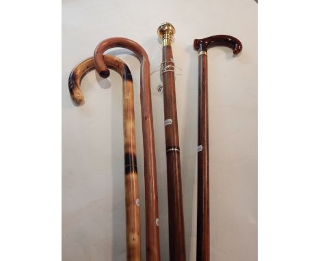 A Victorian style brass mounted sectional walking cane, incorporating a compass and flask, together with three other walking 