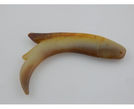 A Chinese jade bead pendant modelled as a fish. L. 11cm