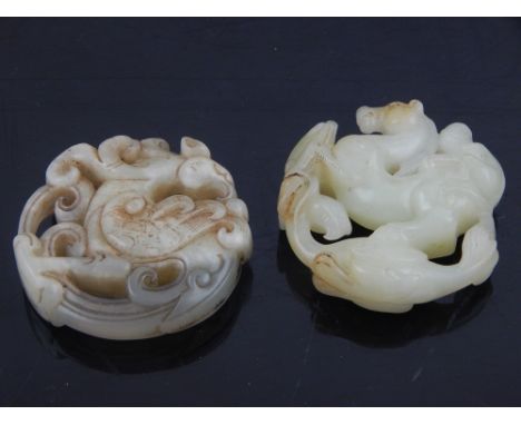 A Chinese jade pendant in the form of a monkey, horse, and bird, together with another Chinese hardstone circular pendant. (2