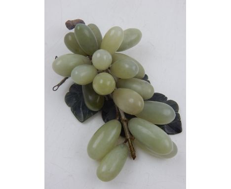 A Chinese green and white jade carving of grapes.