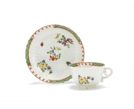 A Worcester teacup and saucer, circa 1755-56Thinly potted and crisply moulded with fine strap-fluting, reserving scrolled pan