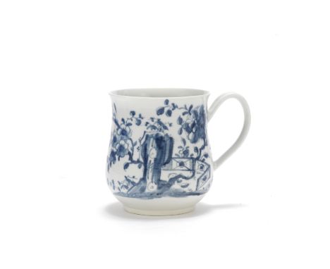 A Worcester mug, circa 1756-58Of bell shape with a broad grooved loop handle, painted in blue with the 'Prunus Fence' pattern