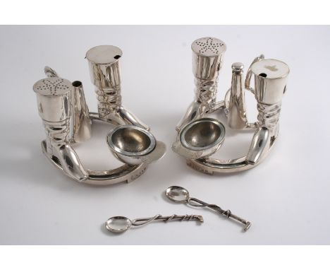 A PAIR OF VICTORIAN ELECTROPLATED NOVELTY CONDIMENT SETS on a hunting theme, each with a horseshoe base, riding hat salt & a 
