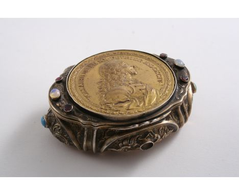 A DECORATIVE CONTINENTAL SILVERGILT SNUFF BOX set with a gilt copper medallion depicting the portrait of Voltaire & gems (one