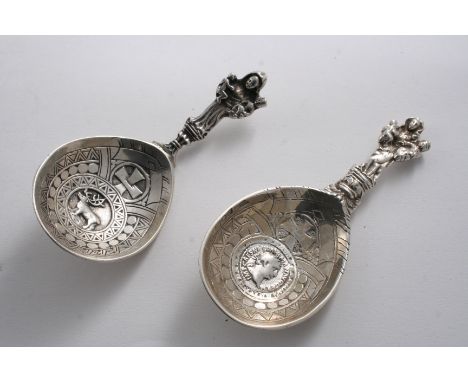 A LATE 19TH CENTURY NORWEGIAN CADDY SPOON with a figural stem & a reindeer in relief in the bowl, c.1900 together with a simi