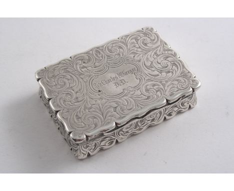 A VICTORIAN ENGRAVED SNUFF BOX of shaped oblong outline, inscribed "Rev. Charles McGregor D.D" on the cover, gilt interior, b
