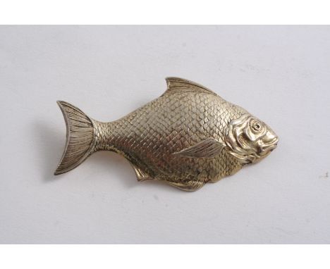 AN EDWARDIAN SILVERGILT CADDY SPOON in the form of a fish (now with a later-added pin & hook for use as a brooch), by T. Brad