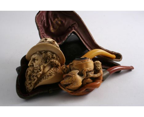 A LARGE MEERSCHAUM PIPE the bowl carved with a bearded Tyrolean gentleman wearing a hat (amber mouthpiece), 19 cms, and anoth