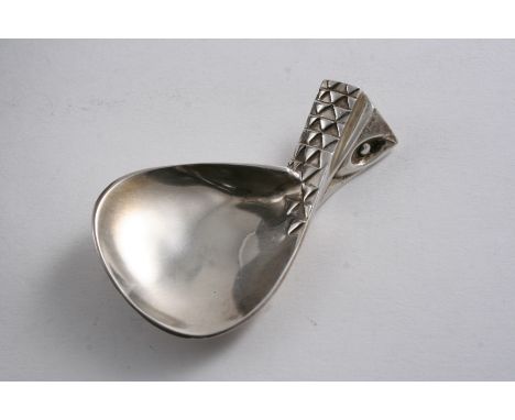 A CONTEMPORARY "EAGLE'S WING" CADDY SPOON with stylised plumage & an eye on the handle, the reverse inscribed "Ray.E.Morris 3