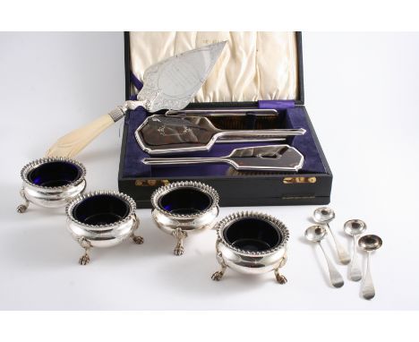 A SET OF FOUR OLD SHEFFIELD PLATED SALTS on three paw feet with gadrooned borders & blue glass liners, crested; a set of four