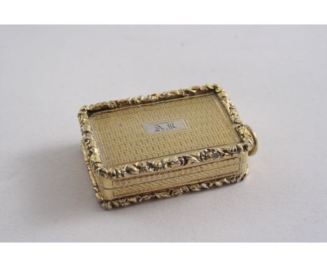 A GEORGE IV SILVERGILT OBLONG VINAIGRETTE with engine-turning, raised floral borders & a suspensory ring, initialled "AK", by