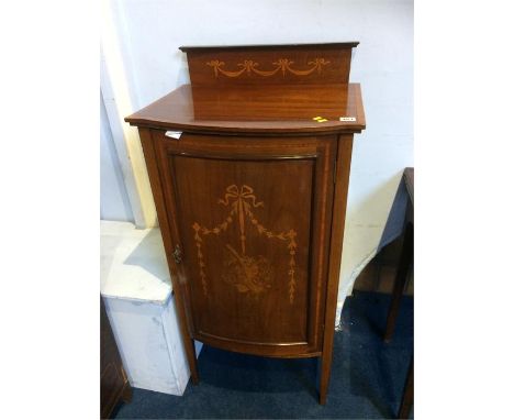 An Edwardian mahogany bow front music cabinet 