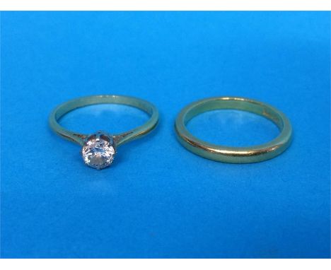 A diamond mounted yellow metal ring and one other
