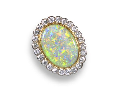 An oval-shaped opal and diamond cluster ring, set within a surround of round brilliant-cut diamonds in yellow and white gold,