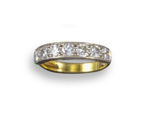 A diamond seven-stone ring, set with round brilliant-cut diamonds in yellow and white gold, size N