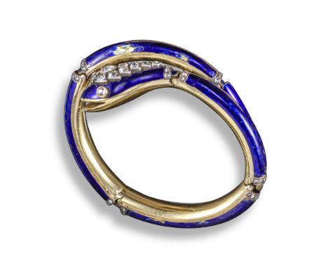A Victorian diamond and enamel serpent bangle, the stylised gold snake decorated with blue enamel and diamonds in yellow gold