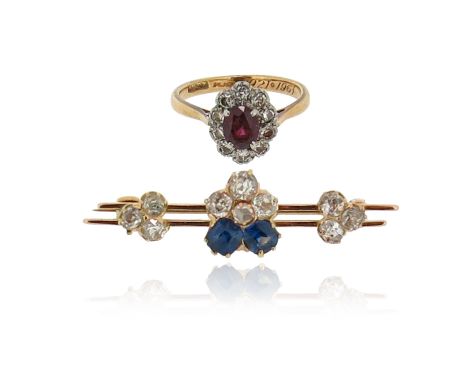 A ruby and diamond cluster ring, the oval-shaped ruby set within a surround of circular-cut diamonds in platinum and yellow g